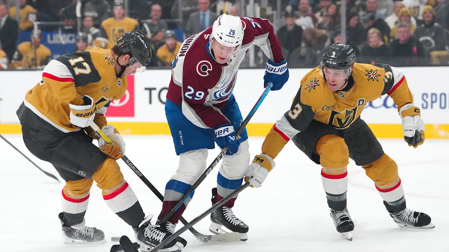 Dec 27, 2025; Las Vegas, Nevada, USA; Colorado Avalanche center Nathan MacKinnon (29) loses the puck between Vegas Golden Knights defenseman Ben Hutton (17) and defenseman Brayden McNabb (3) during the first period at T-Mobile Arena. Mandatory Credit: Stephen R. Sylvanie-Imagn Images