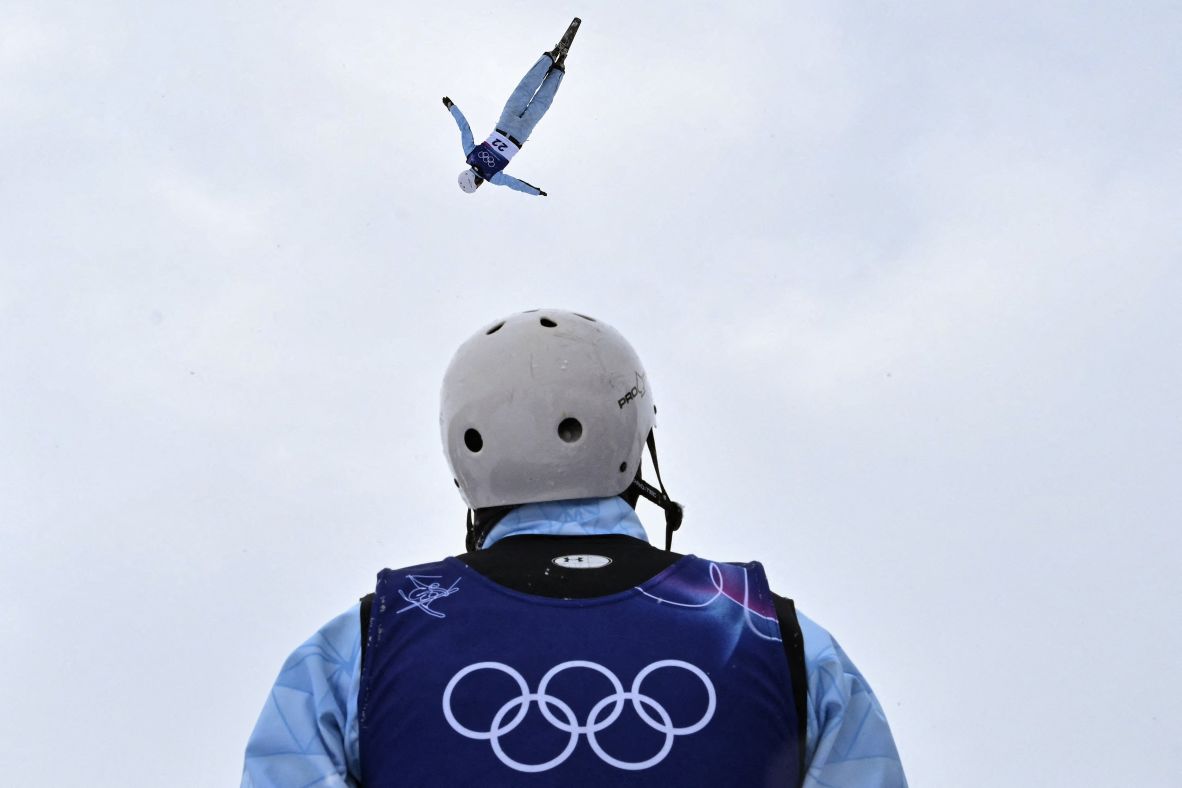 Kazakhstan's Roman Ivanov looks on as teammate Dinmukhammed Raimkulov warms up before the men's freeski aerials competition on February 20.