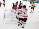 Team Canada's Nathan MacKinnon (#29) celebrates his goal with Connor McDavid during the Men's Preliminary Group A match against Czechia at the Milano Cortina 2026 Winter Olympic Games.