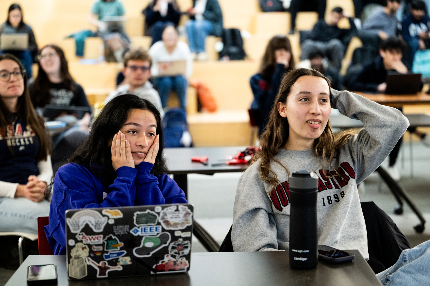 Students sit in rows in Curry student center looking stressed as they watch the gold medal game. 