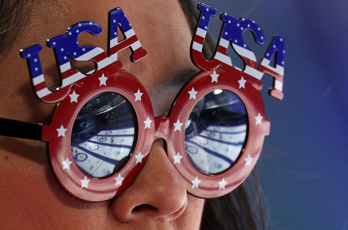 The women's curling semifinals are reflected in the glasses of a US fan on February 20.