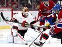 Ottawa Senators goaltender Linus Ullmark (35) watches as Montreal Canadiens centre Joe Veleno (90) is blocked from getting to the puck.