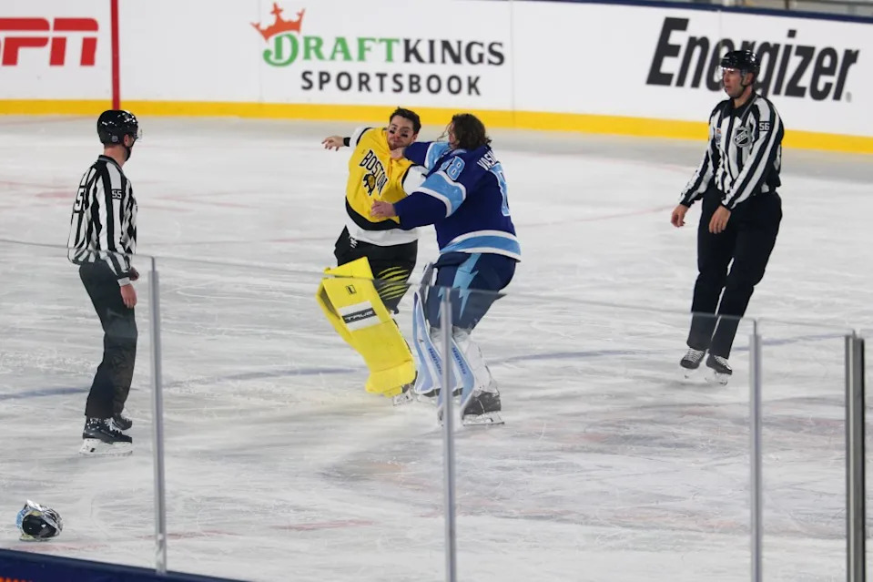 Boston Bruins goaltender Jeremy Swayman (1) and Tampa Bay Lightning goaltender Andrei Vasilevskiy (88) exchange punches as officials Kyle Flemington and Julien Fournier look on during the second period in the 2026 Stadium Series ice hockey game. Nathan Ray Seebeck-Imagn Images