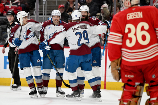 Colorado defenseman Brent Burns (84) celebrates with Colorado defenseman Sam Malinski (70), Colorado left wing Artturi Lehkonen (62) and Colorado center Nathan MacKinnon (29) after scoring a goal against Detroit in the first period of an NHL hockey game Saturday, Jan. 31, 2026 in Detroit. (AP Photo/Lon Horwedel)