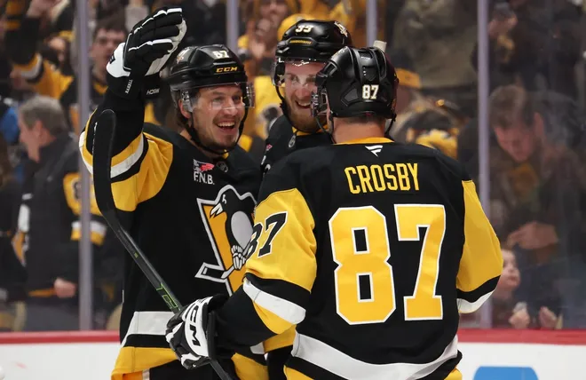 Jan 31, 2026; Pittsburgh, Pennsylvania, USA; Pittsburgh Penguins right wing Rickard Rakell (left) celebrates his goal with right wing Anthony Mantha (39) and center Sidney Crosby (87) against the New York Rangers during the third period at PPG Paints Arena.
