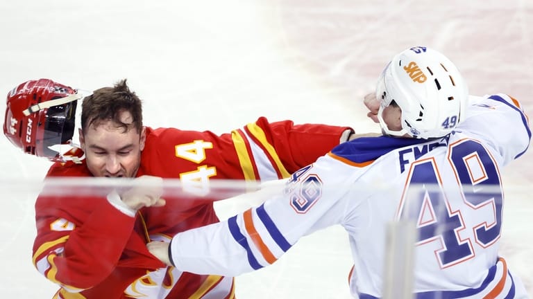 Edmonton Oilers' Ty Emberson, right, fights Calgary Flames' Joel Hanley...