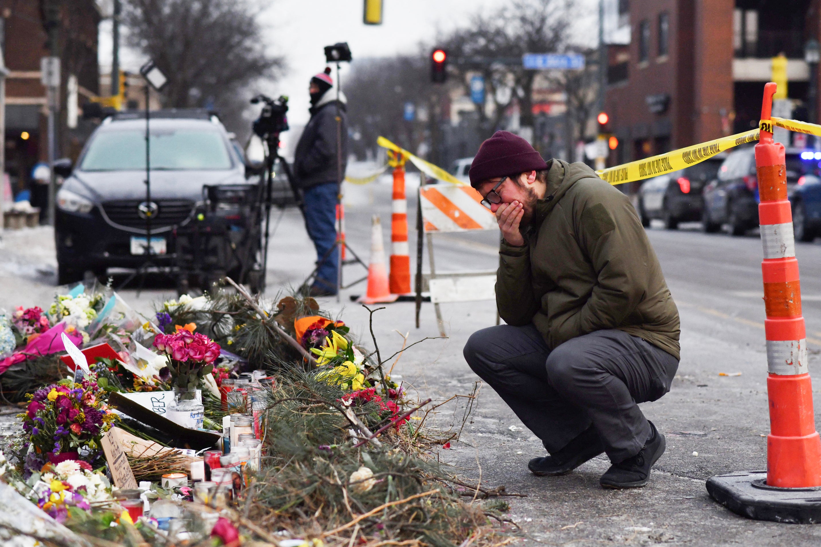 A mourner visits a makeshift memorial on January 25 in the area where Alex Pretti was shot dead a day earlier by federal immigration agents in Minneapolis, Minnesota.