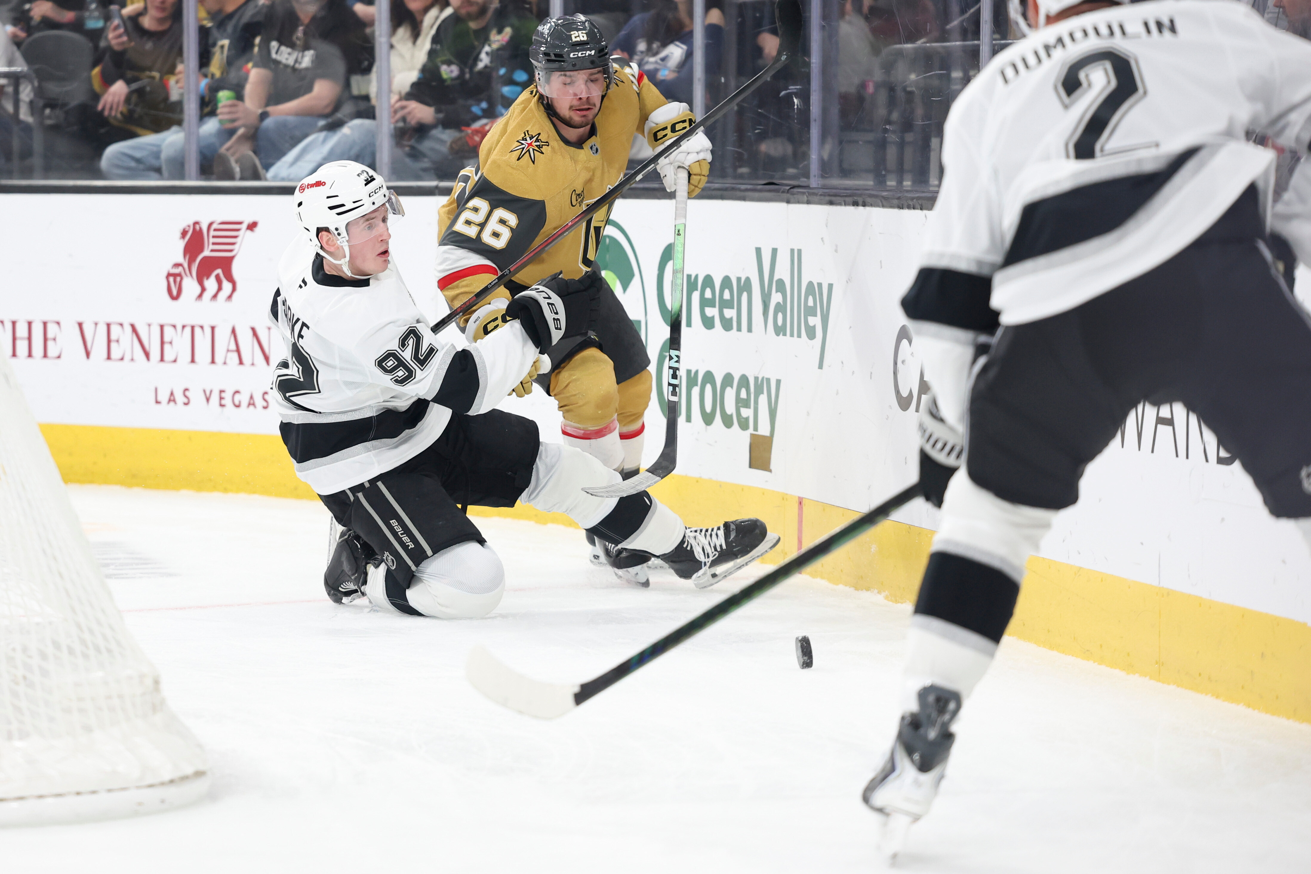 Kings defenseman Brandt Clarke (92) falls after colliding with Vegas...
