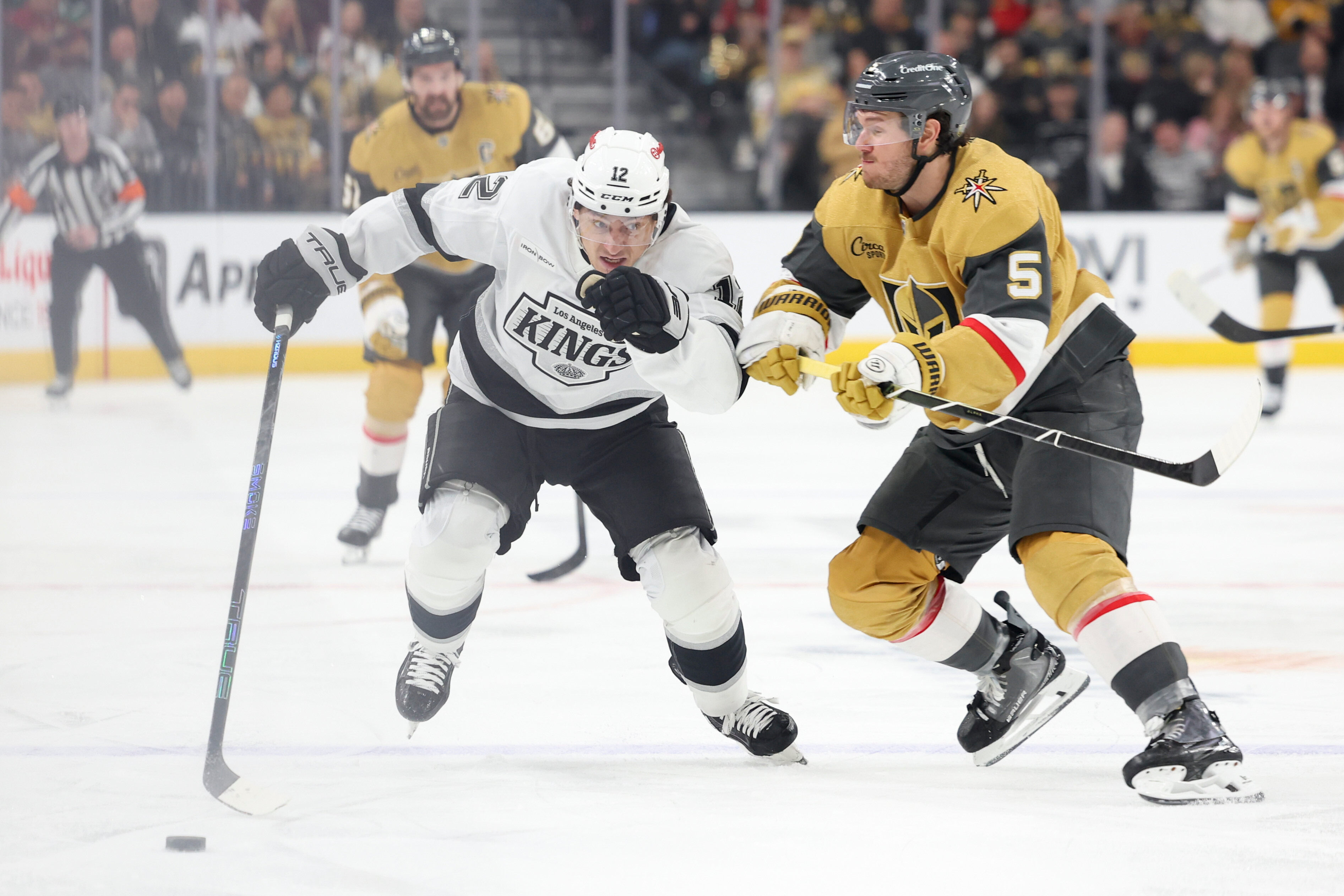 Kings left wing Trevor Moore, left, skates against Vegas Golden...