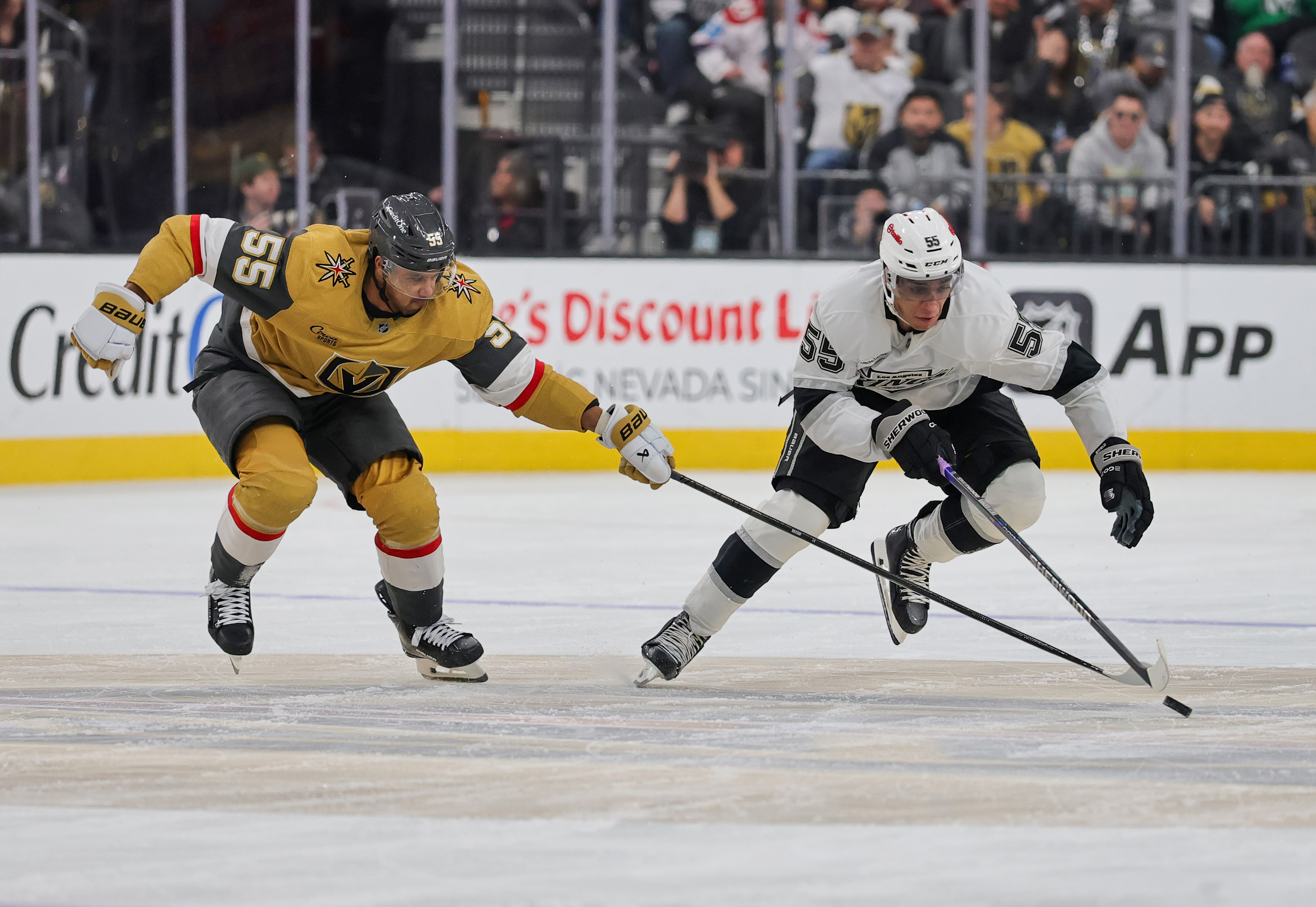 The Kings’ Quinton Byfield, right, skates with the puck against...