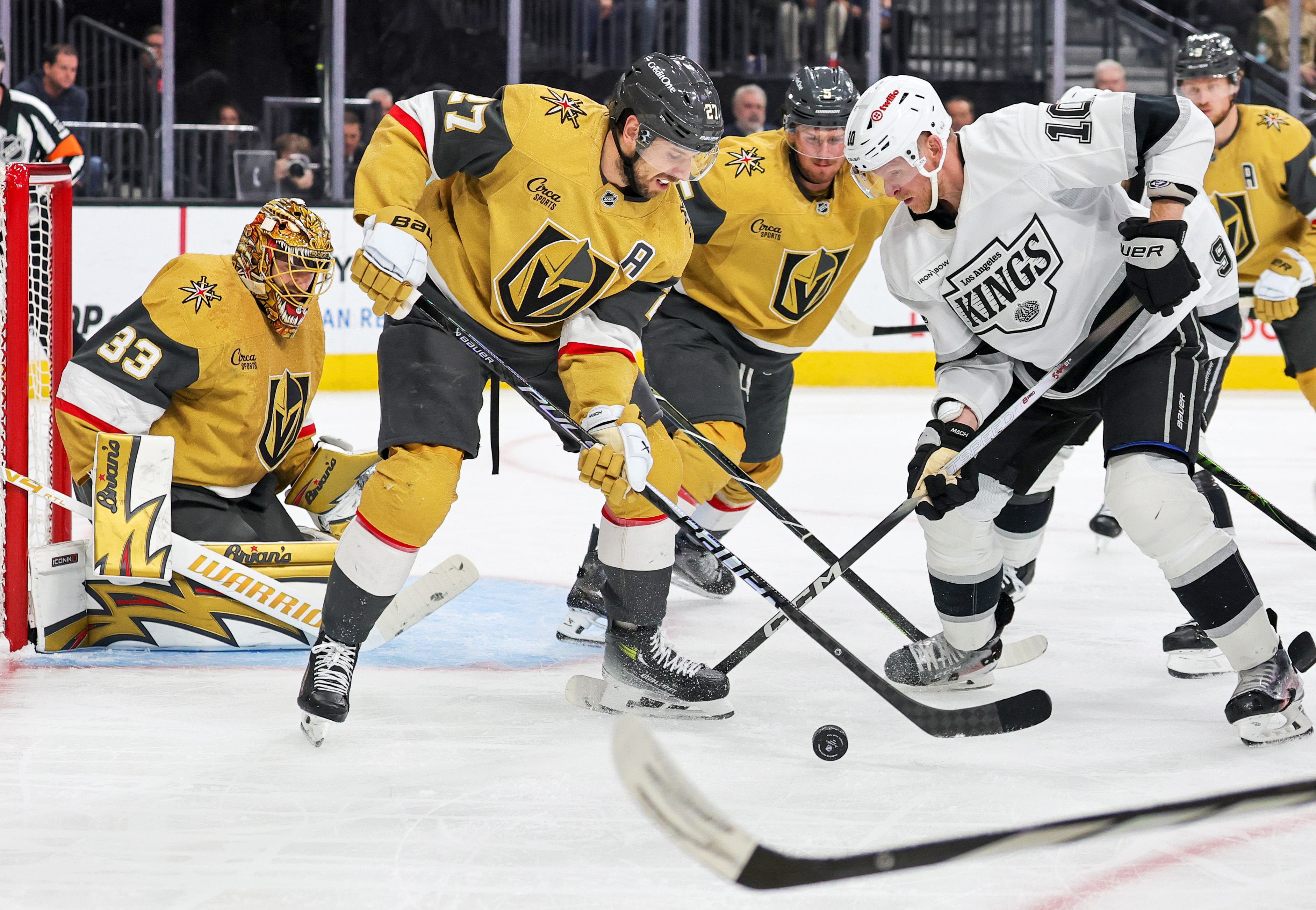 The Vegas Golden Knights’ Shea Theodore (27) and the Kings’...