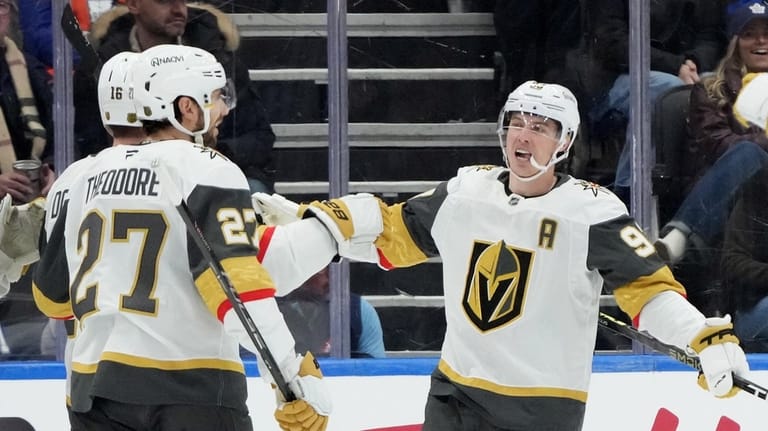 Vegas Golden Knights' Shea Theodore (27), Pavel Dorofeyev (16) and...