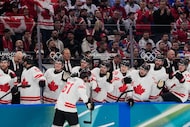 Canada's Mark Stone, center, celebrates with teammates after scoring his sides second goal...