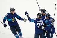 Finland's Nikolas Matinpalo, center, celebrates with teammates after scoring his sides first...