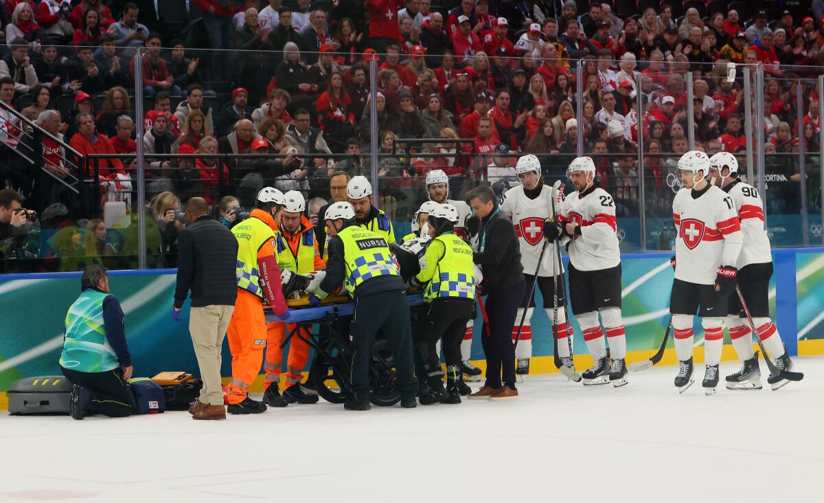 Switzerland's Kevin Fiala is attended to by medical staff after sustaining a broken leg against the Canada on Feb. 13.
