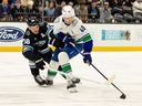 Vancouver Canucks centre Elias Pettersson moves puck against Utah Mammoth defenceman Mikhail Sergachev during Feb. 2 game in Salt Lake City.