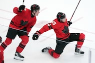 Canada's Mitch Marner (93) and Macklin Celebrini (17) celebrate after Marner scored the...