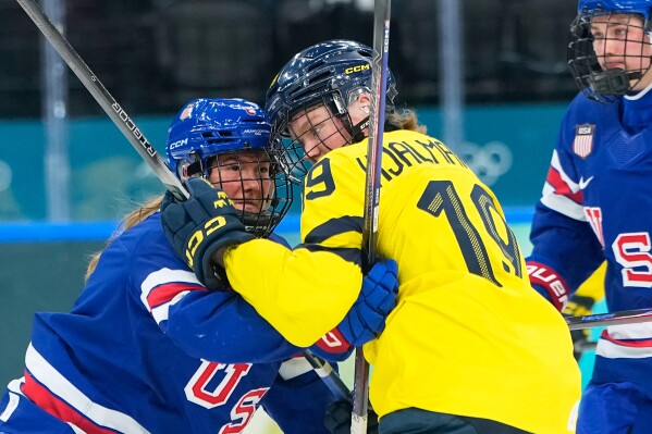 United States' Haley Winn, left, collides with Sweden's Sara Hjalmarsson during a semifinal match of women's ice hockey between the United States and Sweden at the 2026 Winter Olympics, in Milan, Italy, Monday, Feb. 16, 2026. (AP Photo/Petr David Josek)