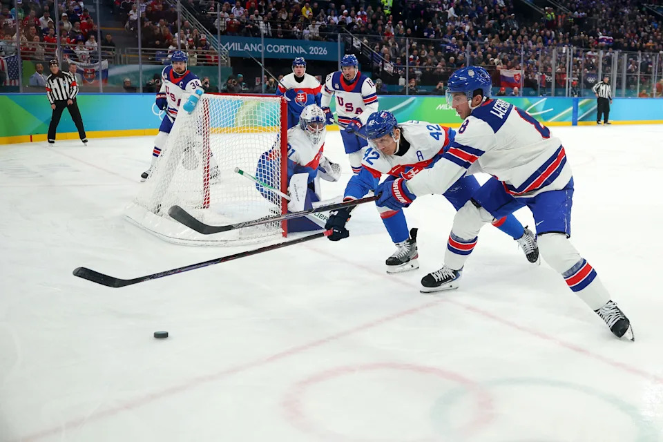 MILAN, ITALY - FEBRUARY 20: Martin Fehervary #42 of Team Slovakia and Zach Werenski #8 of Team United States compete for the puck in the second period during the Men's Semifinals Playoff match between the United States and Slovakia on day fourteen of the Milano Cortina 2026 Winter Olympic games at Milano Santagiulia Ice Hockey Arena on February 20, 2026 in Milan, Italy. (Photo by Gregory Shamus/Getty Images)