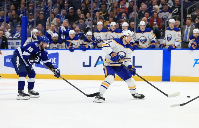 Feb 3, 2026; Tampa, Florida, USA; Buffalo Sabres defenseman Bowen Byram (4) skates with the puck as Tampa Bay Lightning right wing Nikita Kucherov (86) defends during the overtime period at Benchmark International Arena.