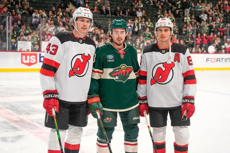 Quinn Hughes #43 of the Minnesota Wild poses for a photo with his brothers Luke Hughes #43 and Jack Hughes #86 of the New Jersey Devils. NHLI via Getty Images