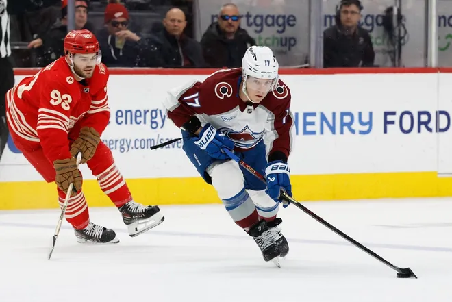 Jan 31, 2026; Detroit, Michigan, USA; Colorado Avalanche center Parker Kelly (17) skates with the puck chased by Detroit Red Wings right wing Alex DeBrincat (93) in the first period at Little Caesars Arena.
