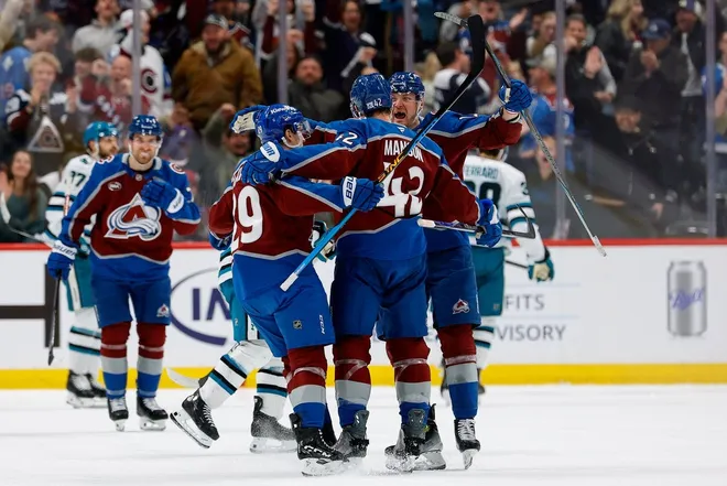 Feb 4, 2026; Denver, Colorado, USA; Colorado Avalanche defenseman Josh Manson (42) celebrates his goal with center Nathan MacKinnon (29) and right wing Valeri Nichushkin (13) in the third period against the San Jose Sharks at Ball Arena.
