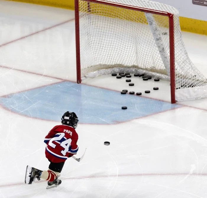  Montreal Canadiens centre Phillip Danault’s son Phillip-Édouard Danault puts the puck in the net during the warm-up for the Canadiens’ skills competition at the Bell Centre on Sunday, February 22, 2026.
