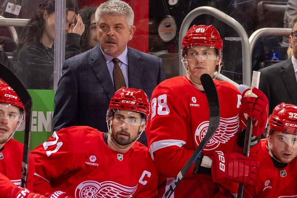 Todd McLellan and Detroit Red Wings players including Dylan Larkin and Patrick Kane present during a game Dave Reginek/NHLI via Getty 