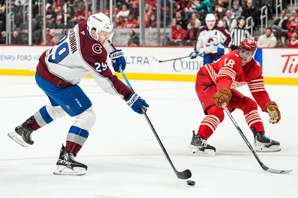 Colorado Avalanche center Nathan MacKinnon (29) shoots the puck against Detroit Red Wings center Andrew Copp (18) during the second period at Little Caesars Arena in Detroit on Saturday, Jan. 31, 2026.