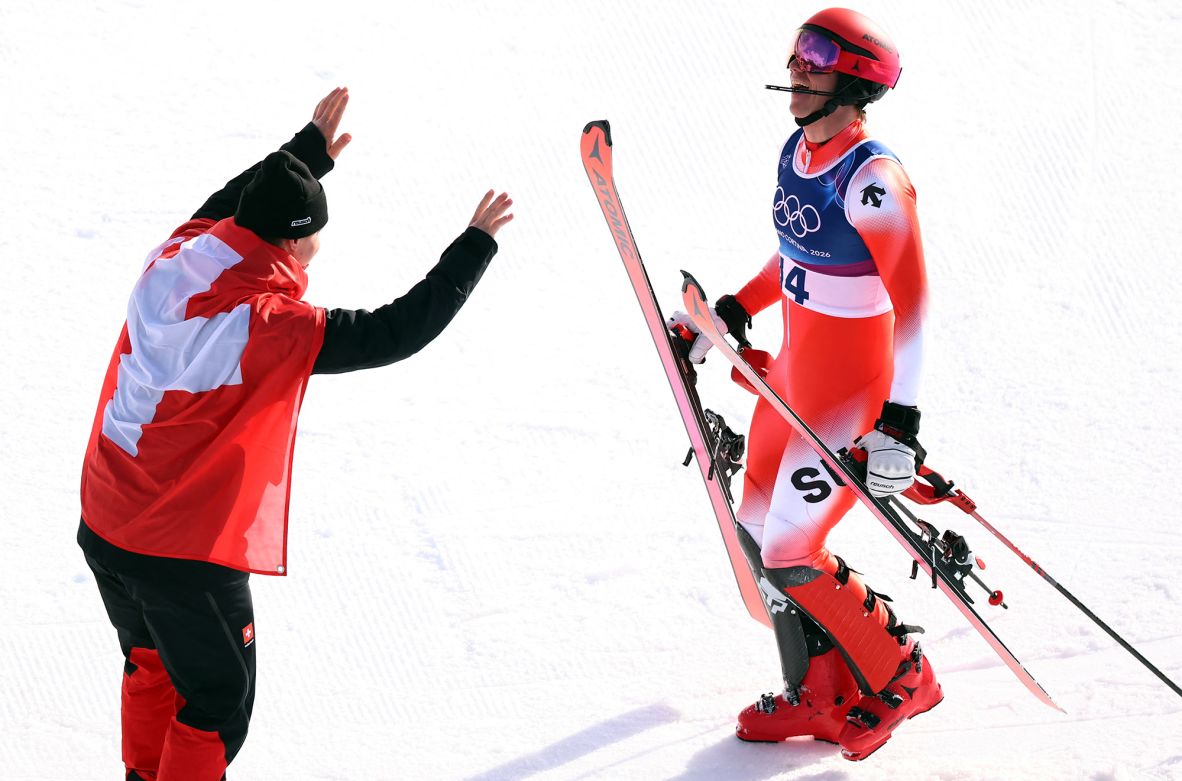 Franjo von Allmen, left, celebrates with Swiss teammate Tanguy Nef after Nef's slalom run in the combined event. Von Allmen skied the downhill portion of the event, and <a href=