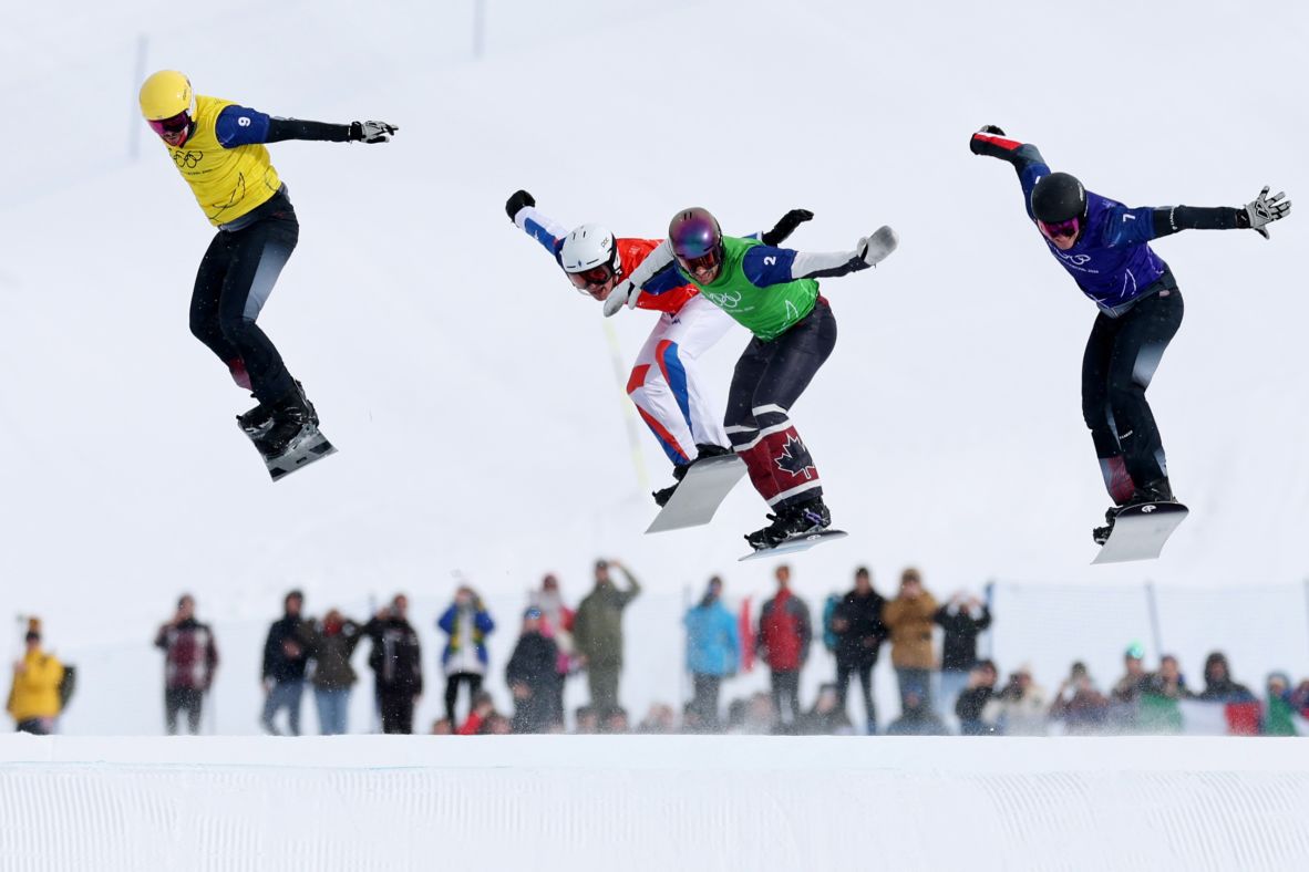 From left, Austria's Jakob Dusek, France's Aidan Chollet, Canada's Éliot Grondin and Austria's Alessandro Hämmerle compete in the snowboard cross final on February 12. <a href=