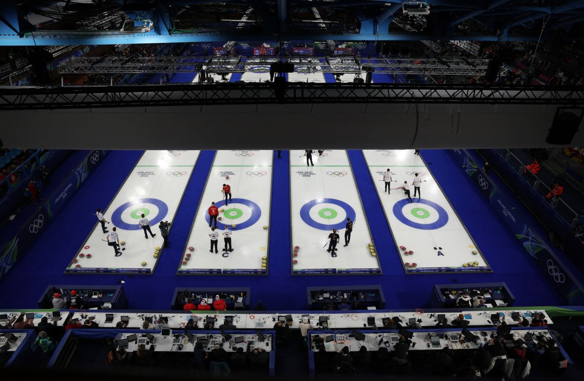 An overhead view of the men's round robin curling event, where four matches were taking place simultaneously on February 14.. The teams competing include Switzerland vs. Canada, the Czech Republic vs. Great Britain, Sweden vs. China and Germany vs. the United States.