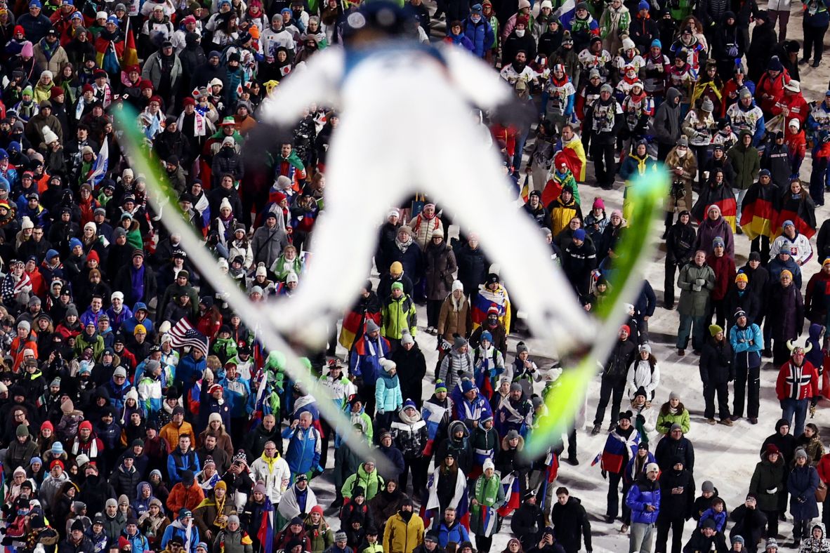 Spectators watch as Annika Belshaw of the United States competes in women's large hill ski jumping on February 15.