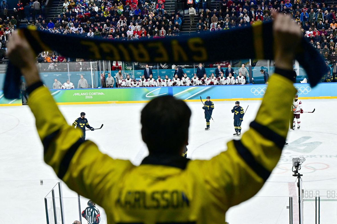 A Sweden fan cheers during their hockey game against Latvia on February 17. <a href=