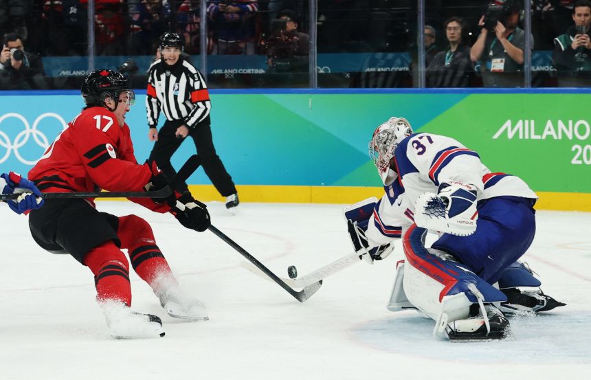 Macklin Celebrini of Canada shoots at goal as Connor Hellebuyck of United States makes a save.
