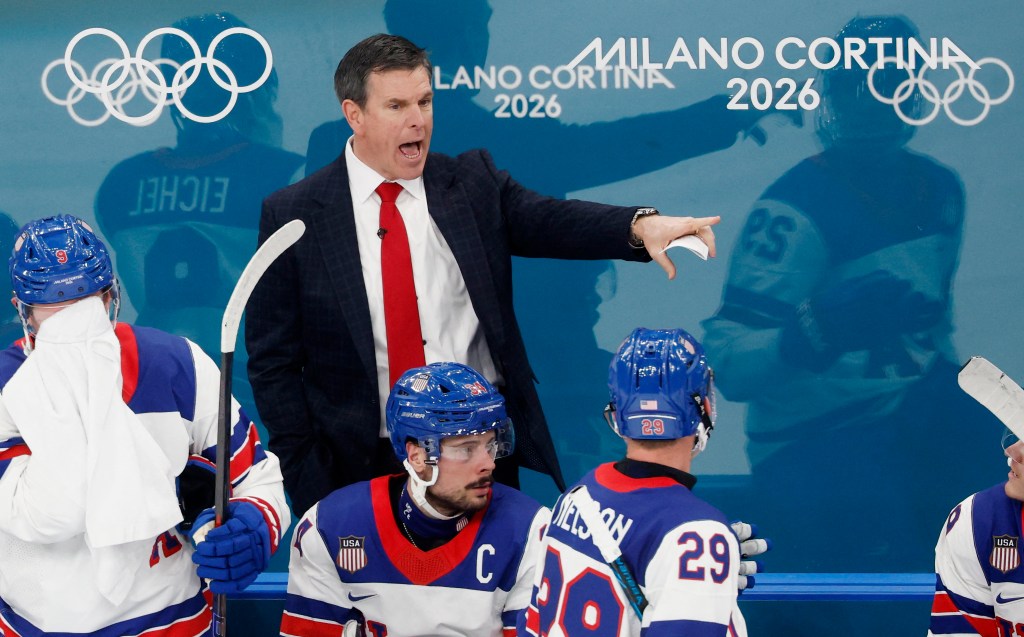 Mike Sullivan, coach of the US men's hockey team, gestures while addressing players on the bench.