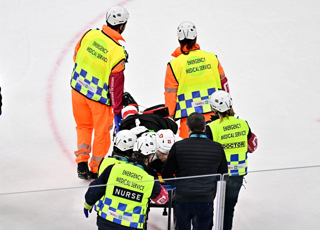 Kevin Fiala is stretchered off the ice during the Switzerland-Canada Olympic game on Feb. 13, 2026. 