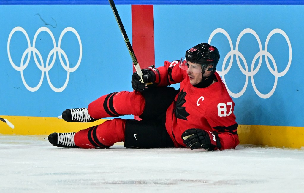 Sidney Crosby of Canada reacting after sustaining an injury during an ice hockey game.