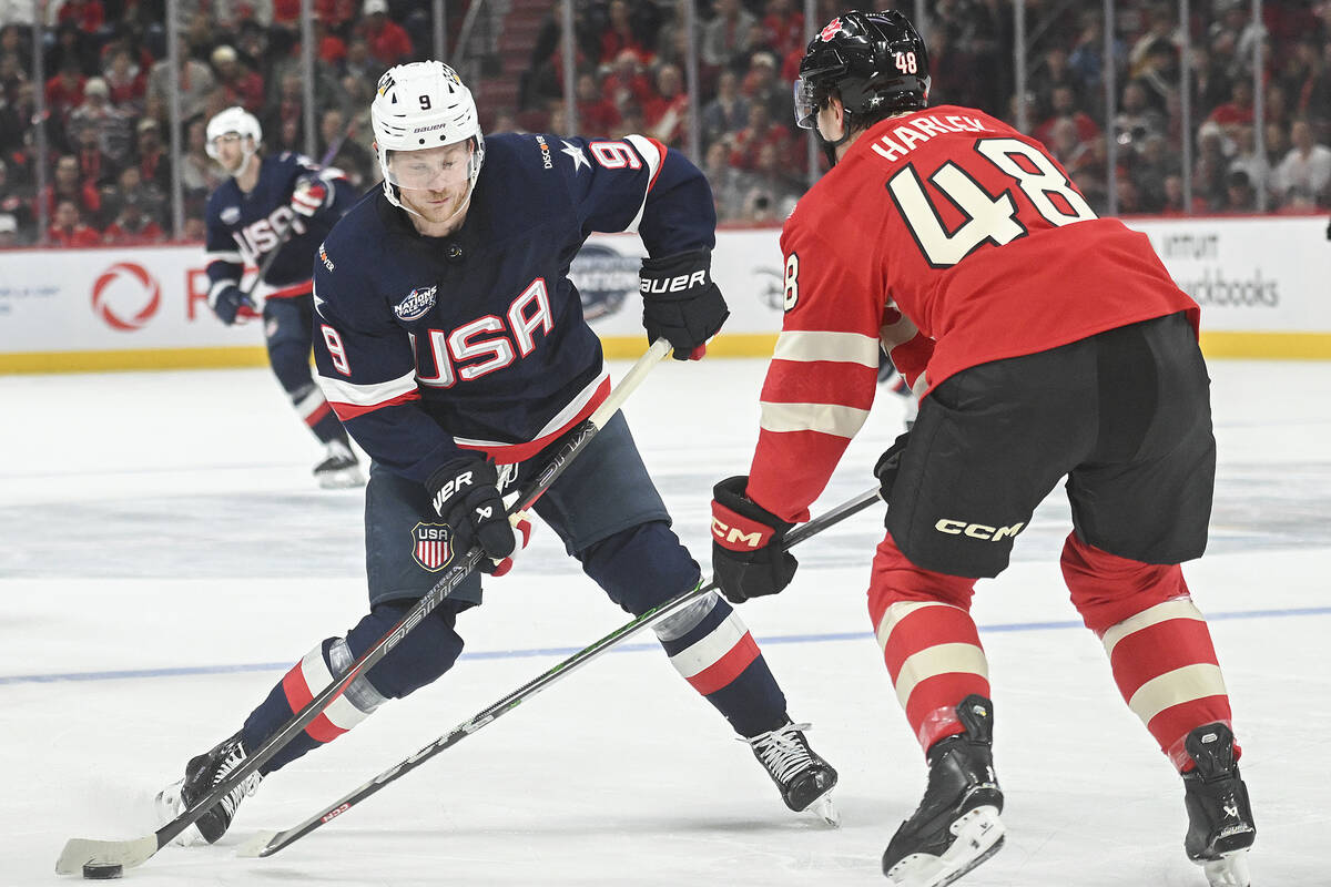 United States' Jack Eichel (9) takes a shot as Canada's Thomas Harley (48) defends du ...