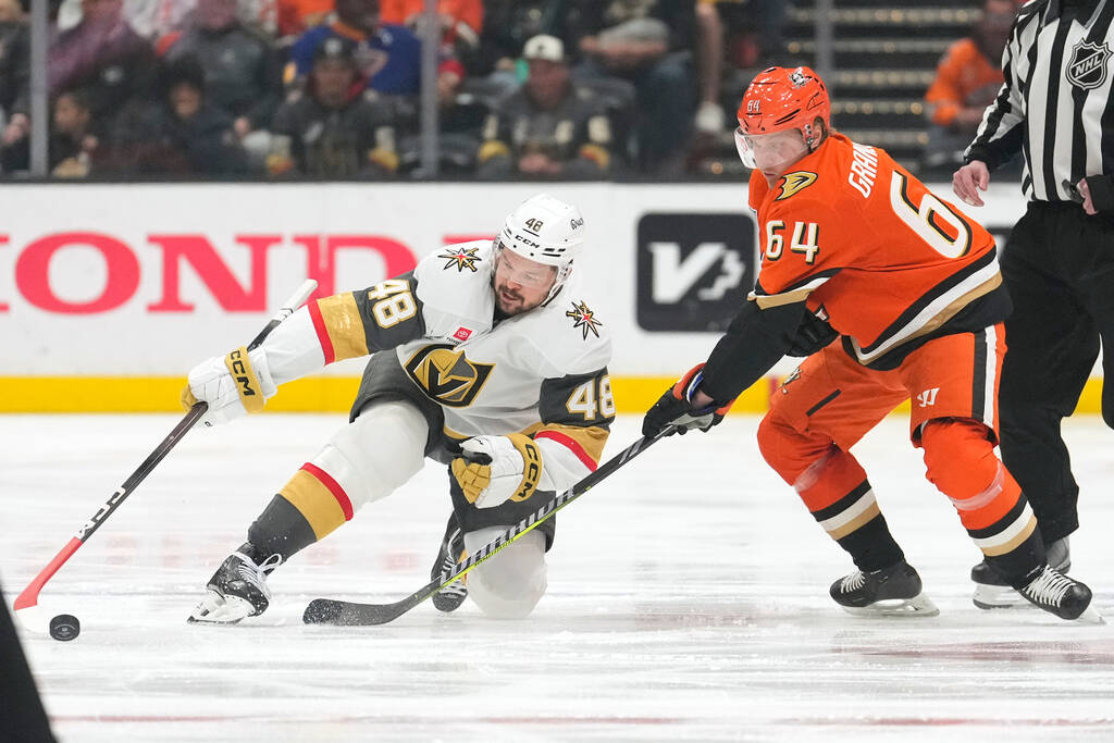 Vegas Golden Knights center Tomas Hertl, left, falls as he goes after the puck along with Anahe ...