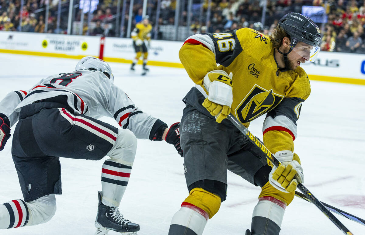 Golden Knights right wing Jonas Rondbjerg (46) takes the puck away from Chicago Blackhawks cent ...