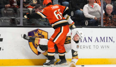 Vegas Golden Knights right wing Jonas Rondbjerg, right, falls after being hit by Anaheim Ducks ...