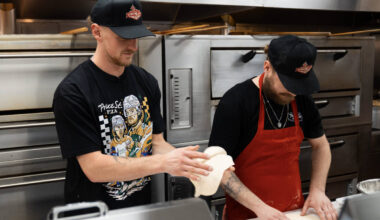Golden Knights center Jack Eichel (left) prepares dough at Prince St. Pizza's Serene Avenue loc ...