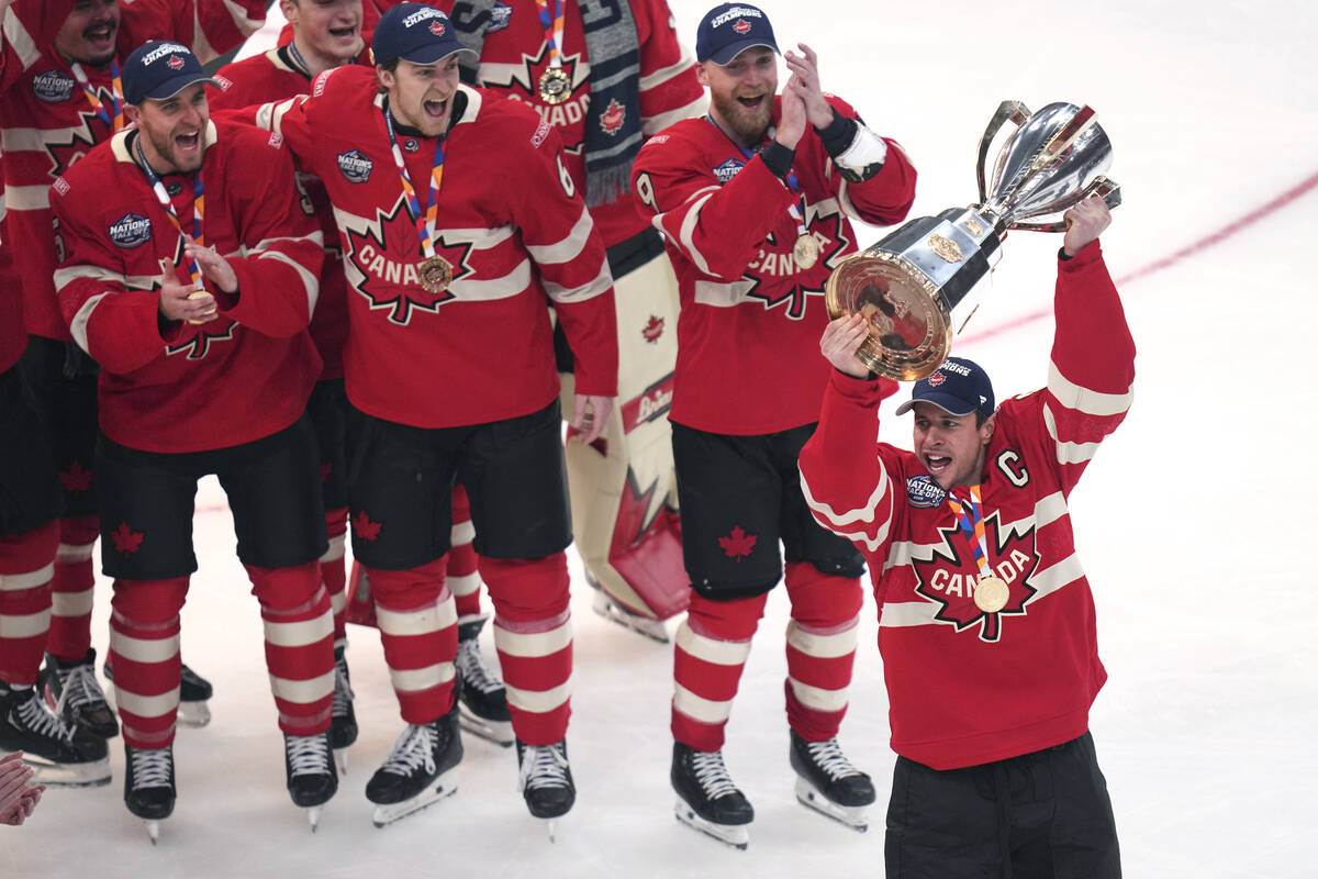 Canada captain Sidney Crosby, right, hoists the trophy after defeating the United States follow ...