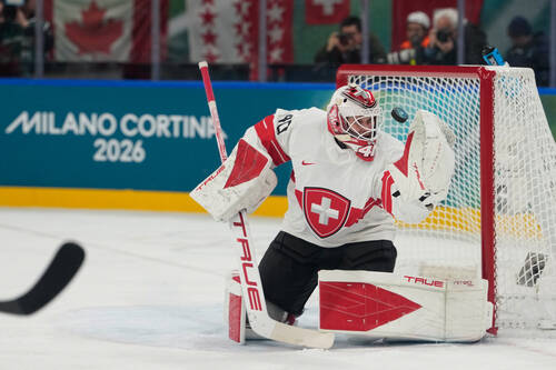 Switzerland's goalkeeper Akira Schmid eyes the puck during a preliminary round match of me ...