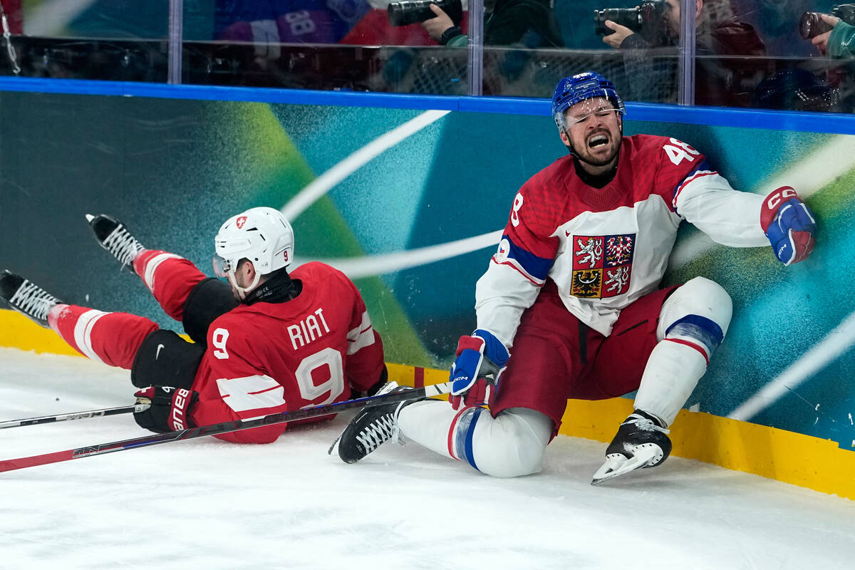 Czechia's Tomas Hertl (48) is challenged by Switzerland's Damien Riat (9) during a pr ...