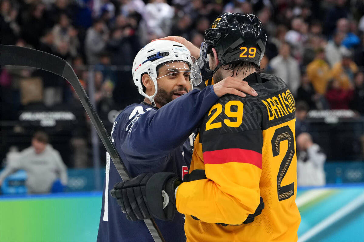 Germany's Leon Draisaitl (29) and France's Pierre-Edouard Bellemare talk after a men& ...