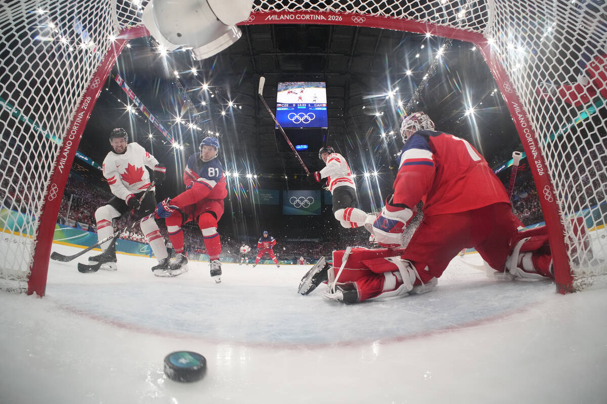 Canada's Mark Stone (61), left, scores a goal in the second period as Czechia's Domin ...