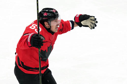 Canada's Brad Marchand celebrates after teammate Shea Theodore scored against Finland duri ...